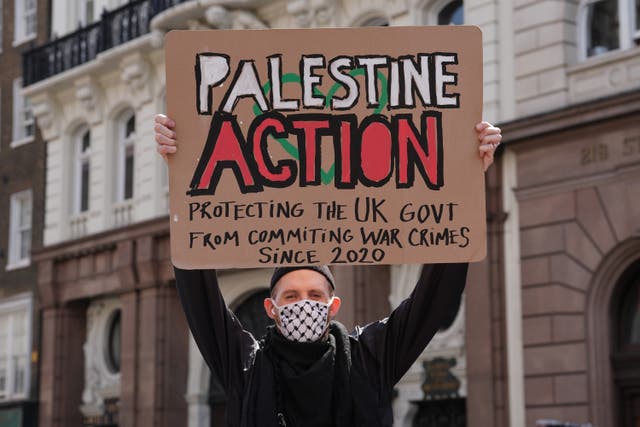 A protester outside the Royal Courts of Justice on The Strand, central London, ahead of a hearing over whether proscribing of Palestine Action should be temporarily blocked. (PA)