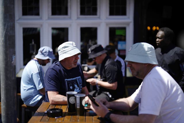 <p>No chance of any sunburn on the heads of these Oasis fans </p>