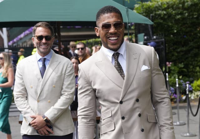 <p>Anthony Joshua with Eddie Hearn at Wimbledon (Andrew Matthews/PA)</p>