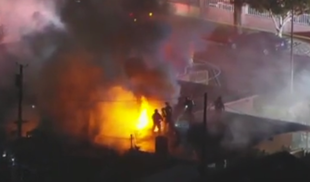 <p>Firefighters tackle a blaze after fireworks detonated in Pacoima, California. One person was killed in the incident. </p>