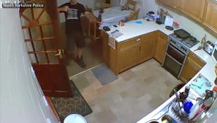 Husband prepares bow and arrow in kitchen before attacking wife