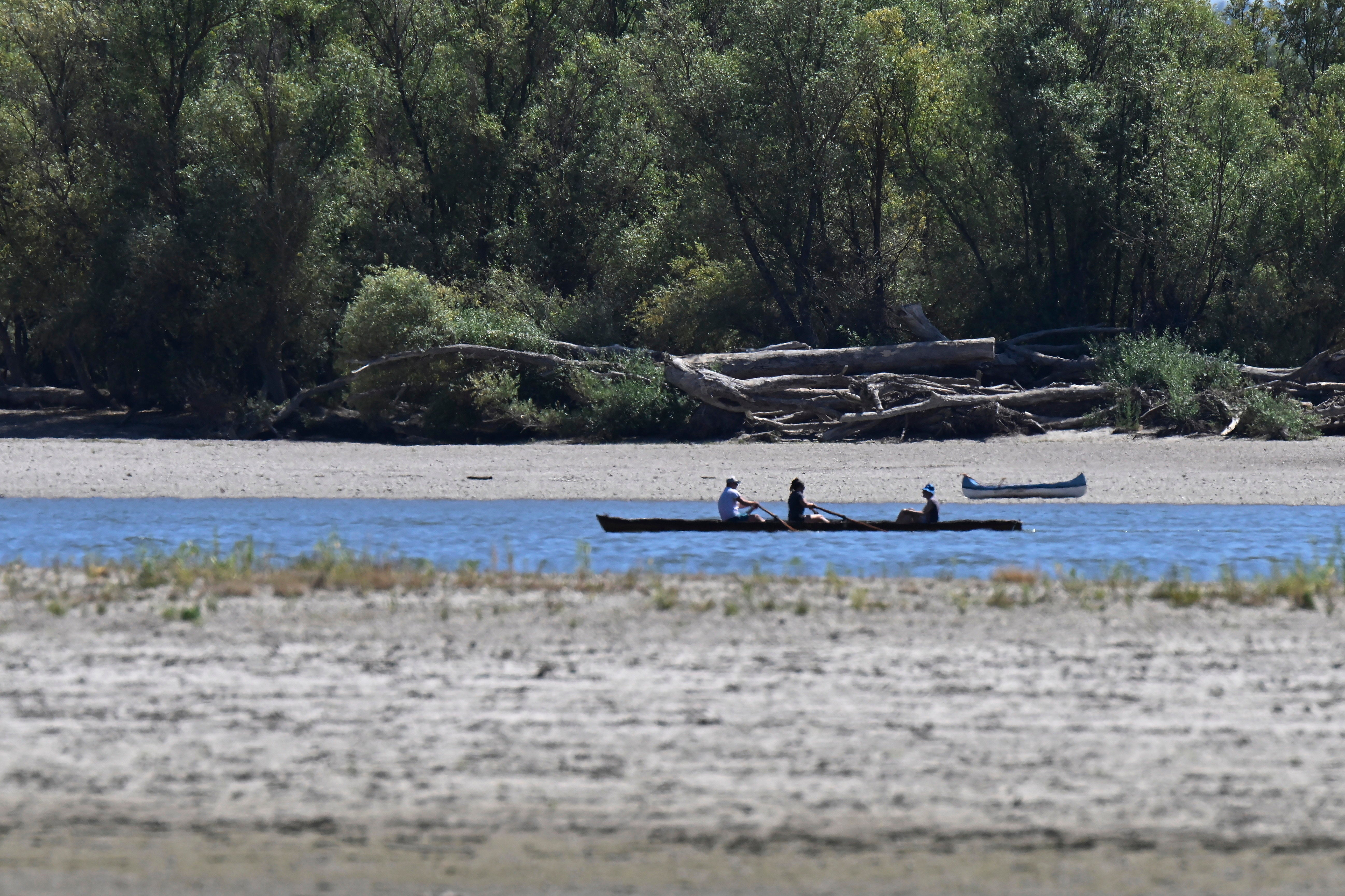 Kayakers pass by the sandbanks of the River Danube near Nagymaros, Hungary