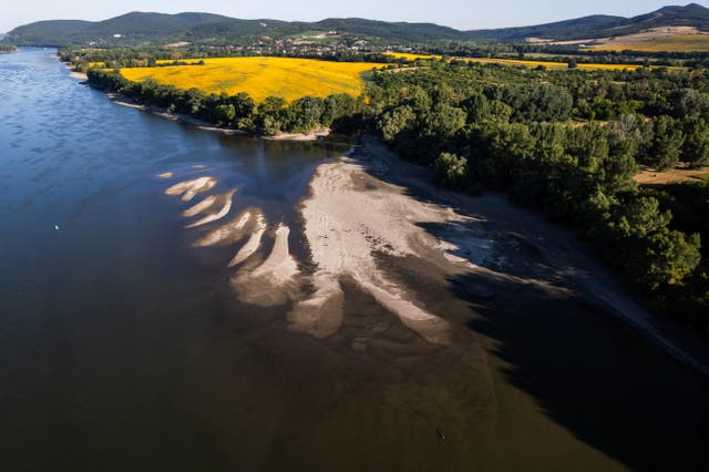 <p>A drone view shows sandbanks emerging from the water due to the low water level of the Danube at its confluence with the Ipoly near Szob, Hungary</p>