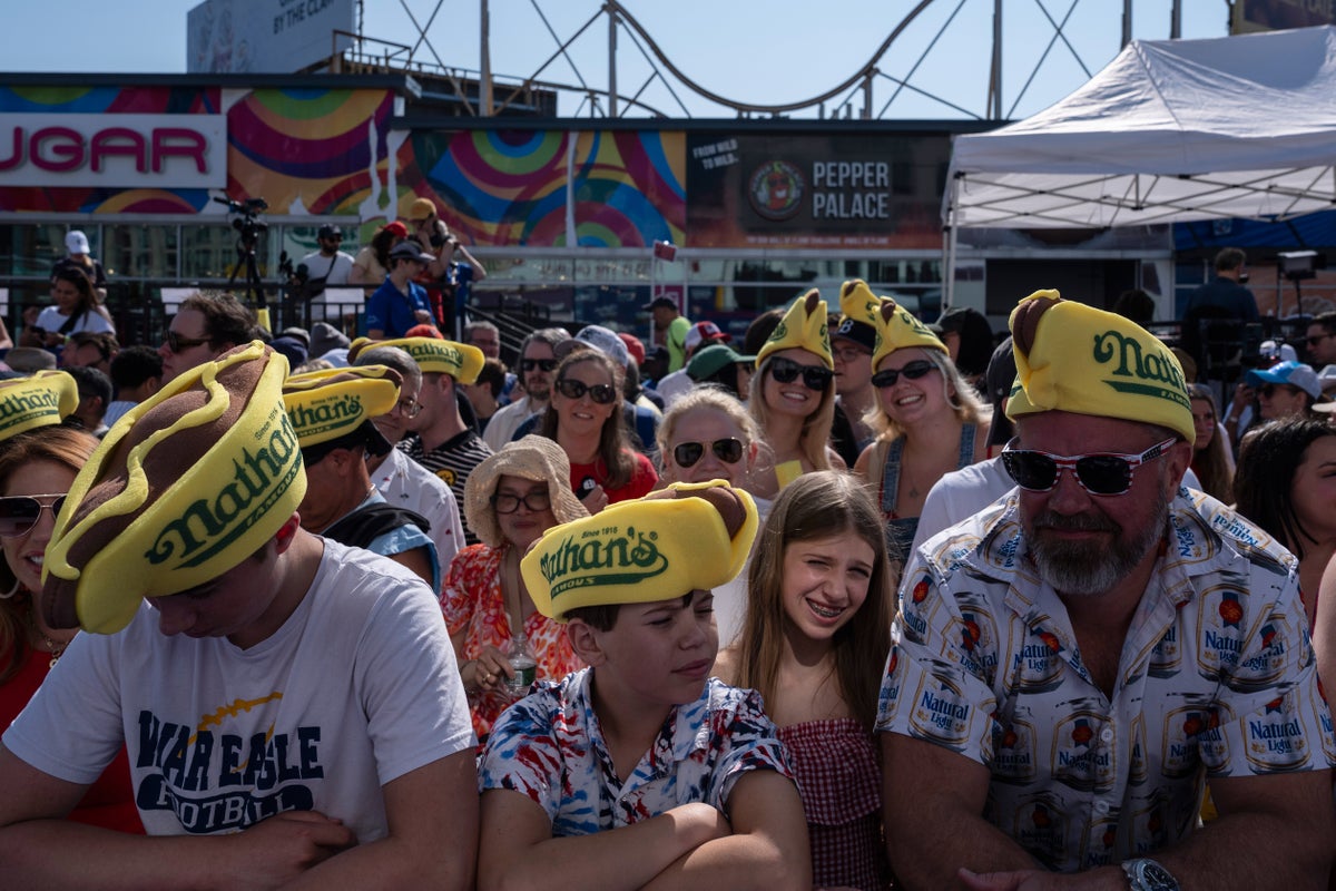 Photos show revelers and competitors alike savoring a July Fourth hot dog eating contest