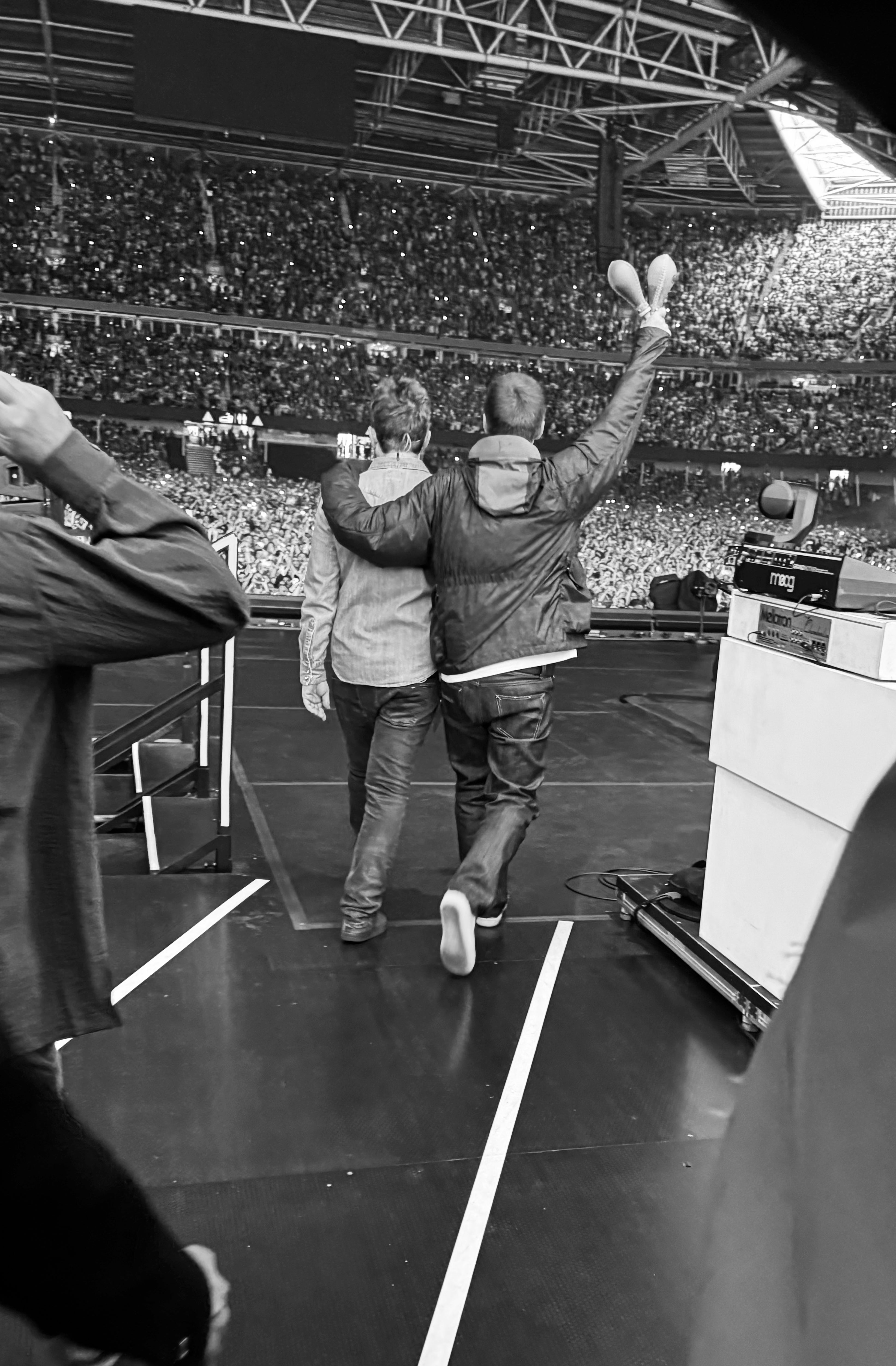 Noel and Liam Gallagher arrive onstage at the Principality Stadium in Cardiff, 4 July 2025