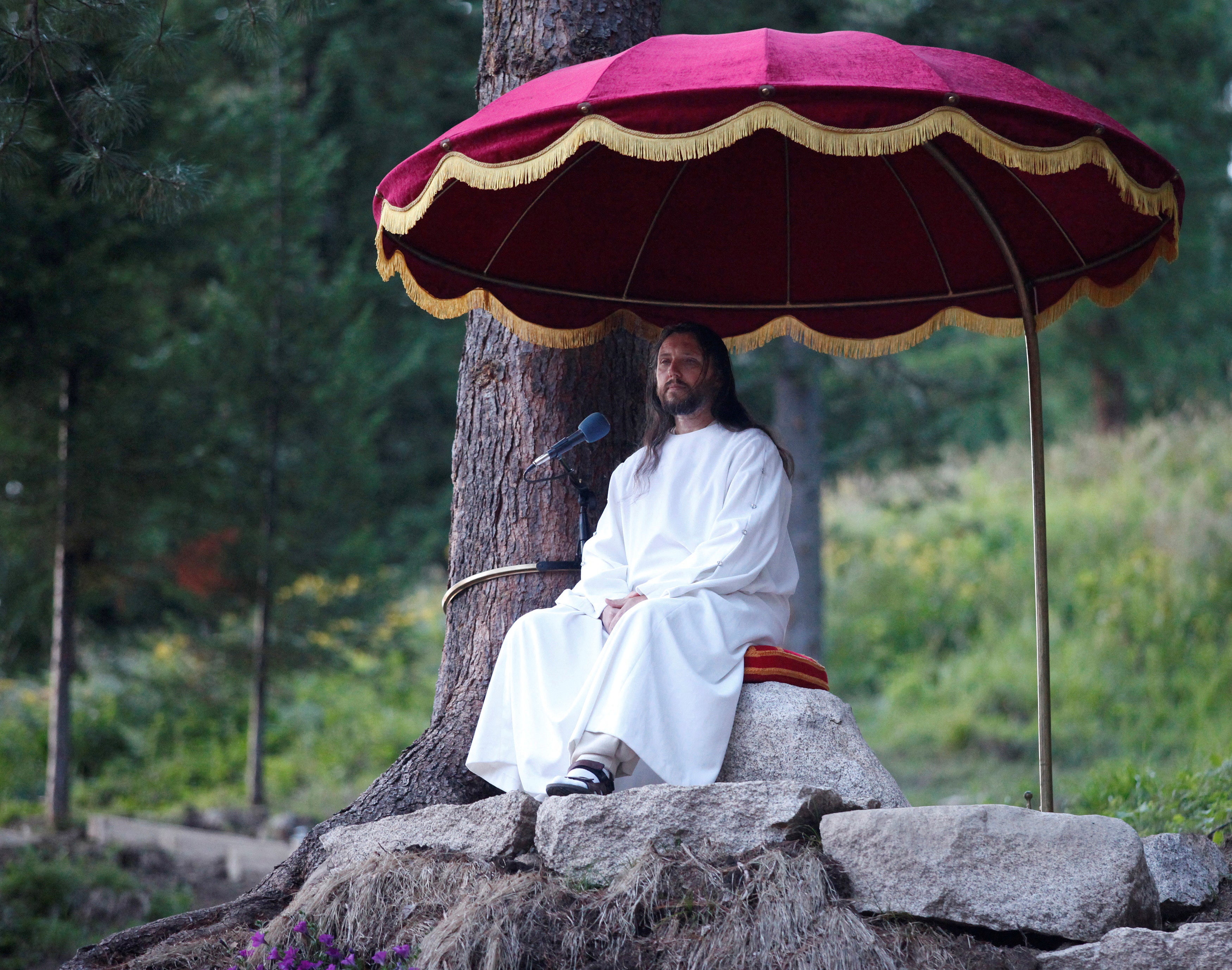 Torop, who has proclaimed himself a new Christ, conducts a service during the Holiday of Good Fruit feast in the village of Obitel Rassvet