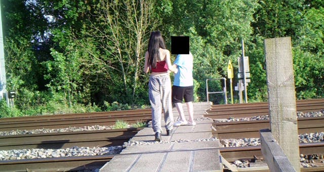 <p>Footage shows children filming and photographing themselves in the middle of the track</p>
