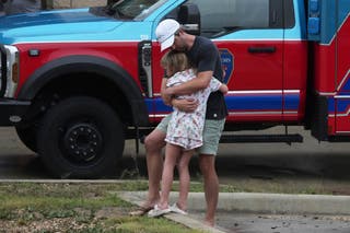 People are reunited at a reunification center after flash flooding hit the area, Friday, July 4, 2025, in Ingram