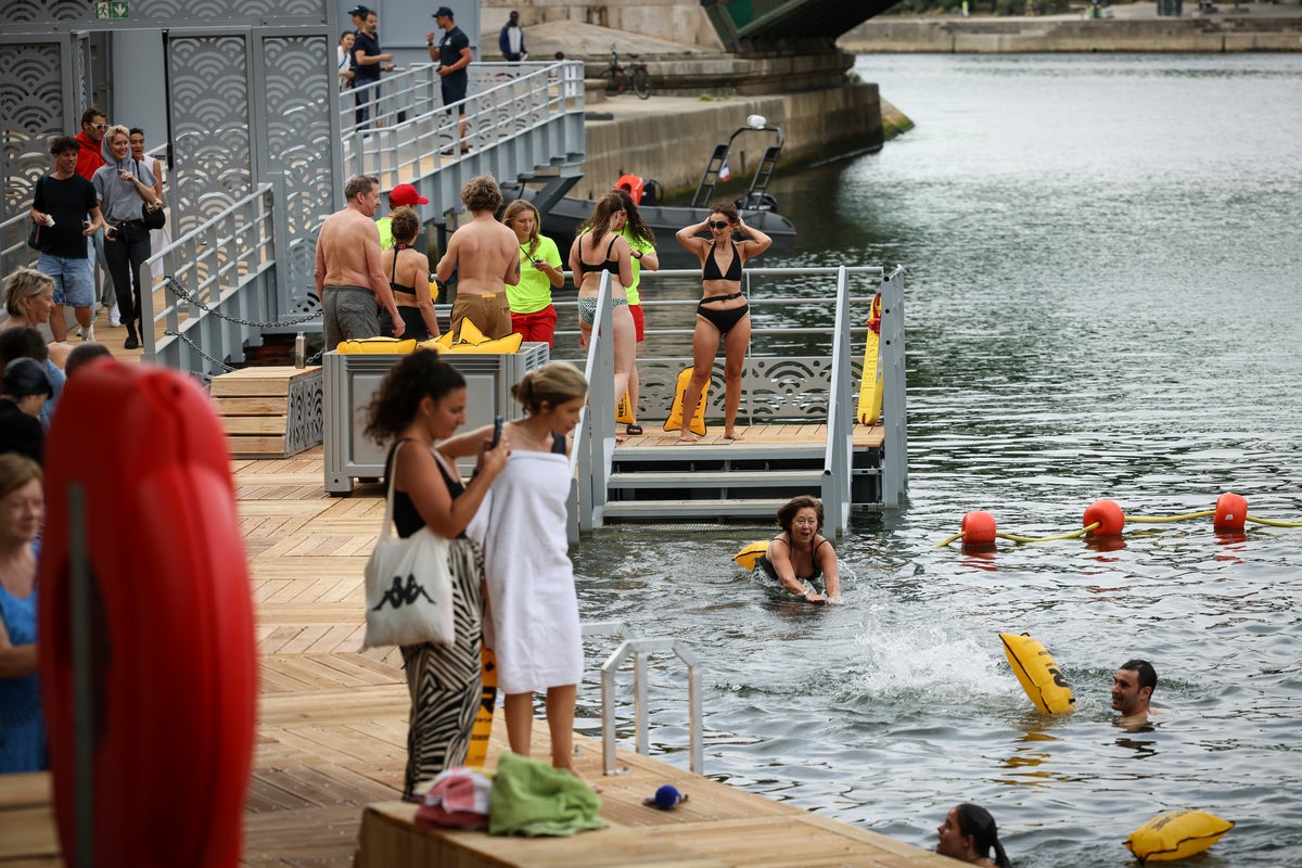 Joyful Parisians take a historic plunge into the Seine after 100 years