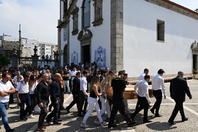 Diogo Jota’s wife Rute Cardoso walks with the coffin after the funeral of the footballer and his brother in Portugal (PA)