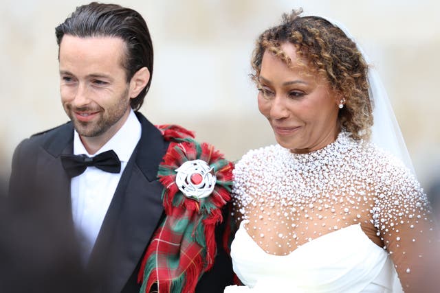 <p>Spice Girl Melanie Brown, Mel B, and her husband hairdresser Rory McPhee leave St Paul’s Cathedral, London, following their wedding (Toby Shepheard/PA)</p>