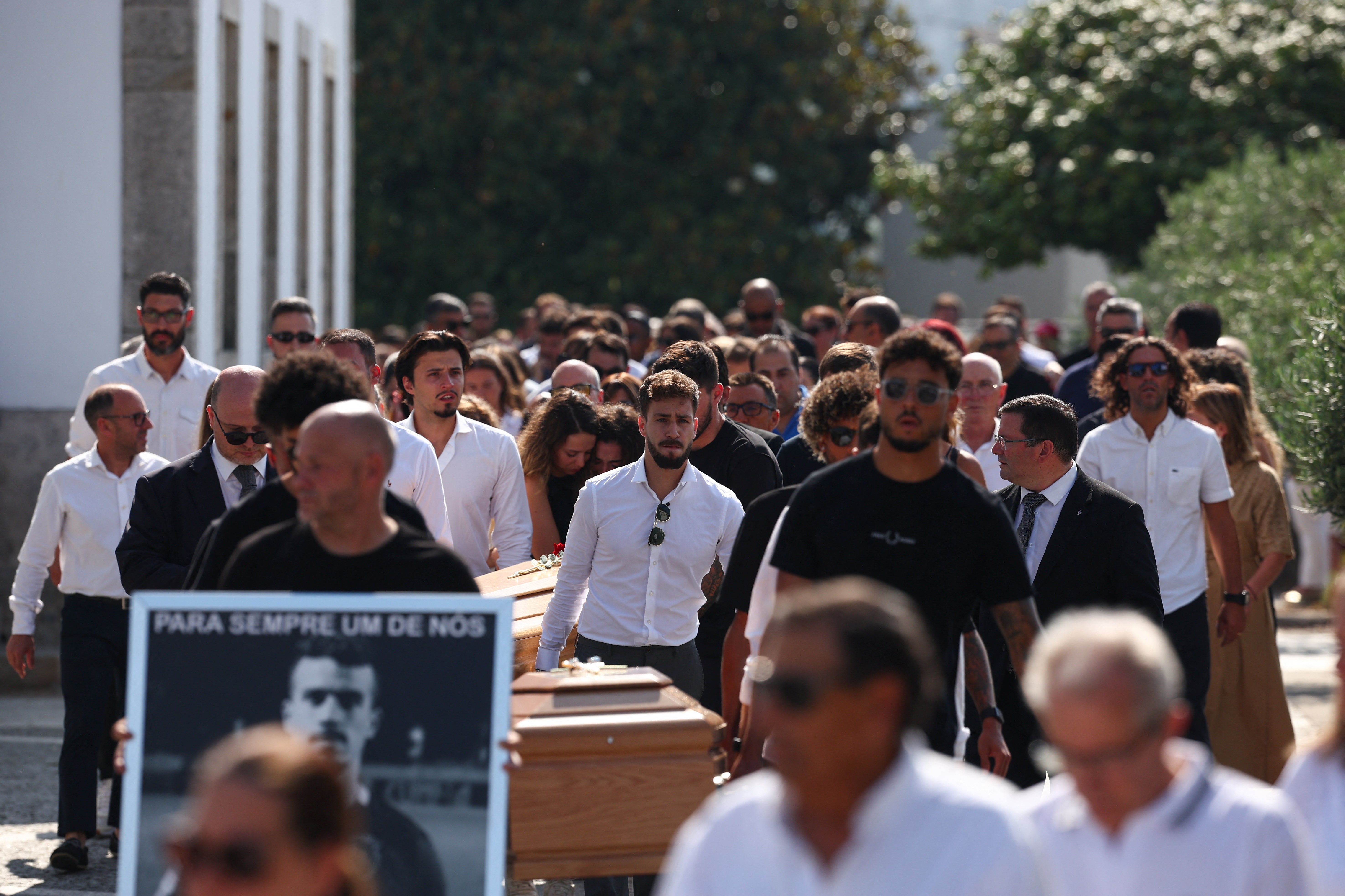 Pallbearers carry coffins Liverpool's Portuguese soccer player Diogo Jote and his brother Andre Silva