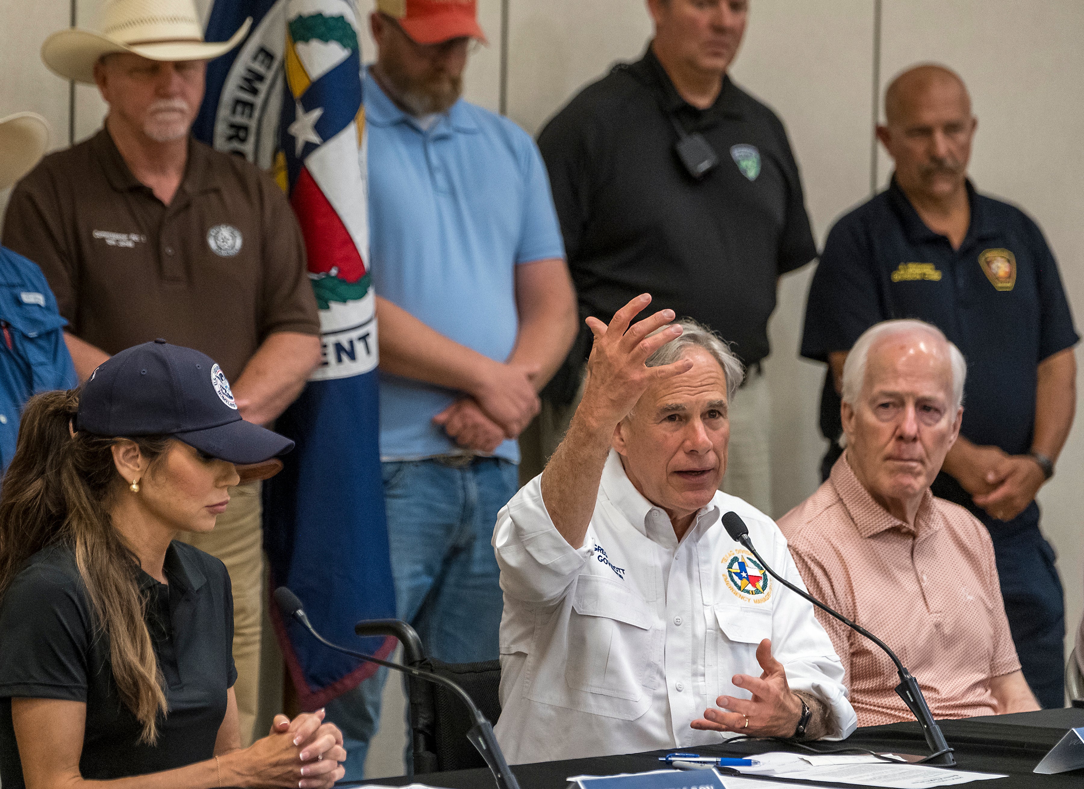 Texas Gov. Greg Abbott, center, speaks to media during a press conference as Homeland Security Secretary Kristi Noem