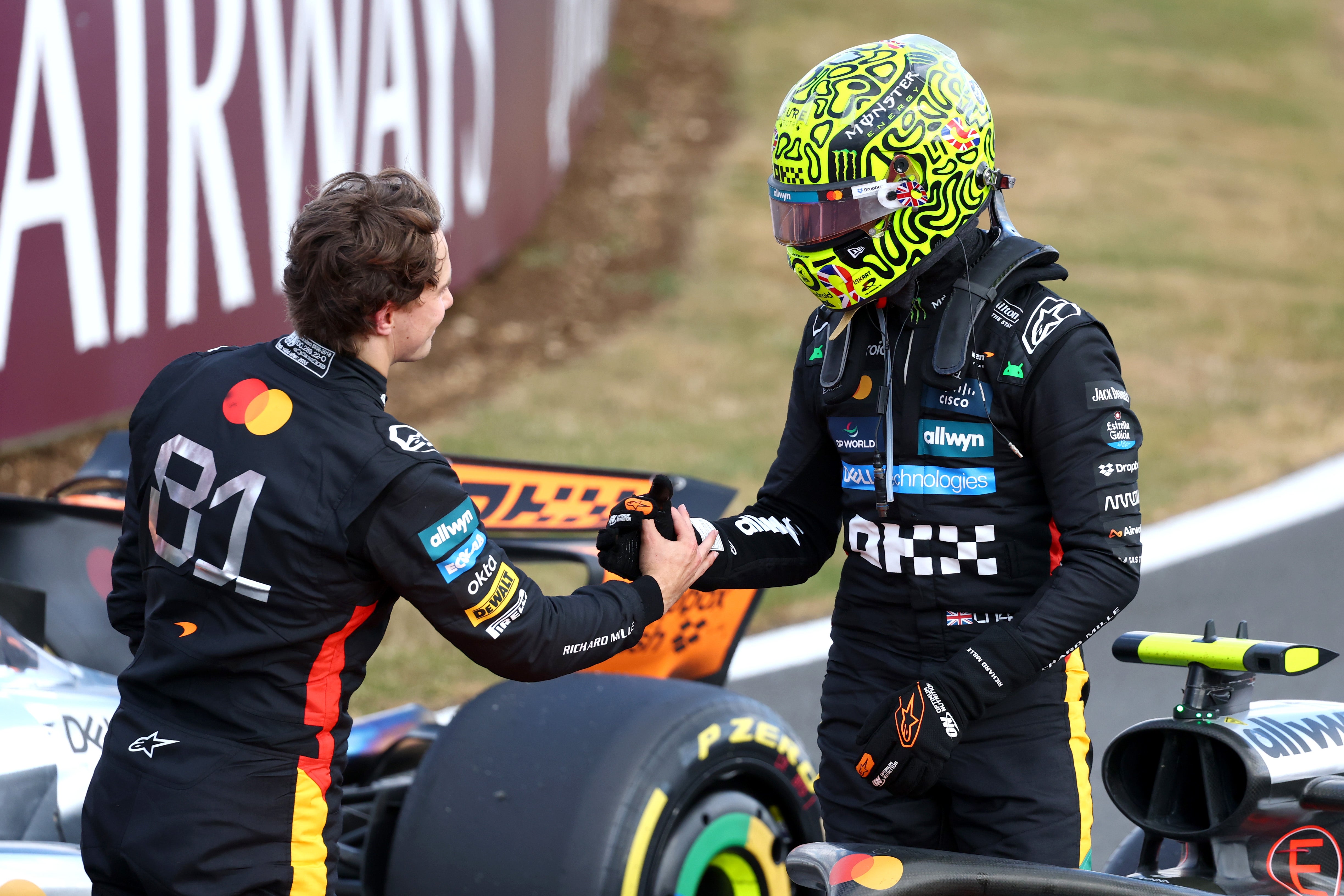 Piastri (left) congratulates McLaren teammate Lando Norris on victory at his home race