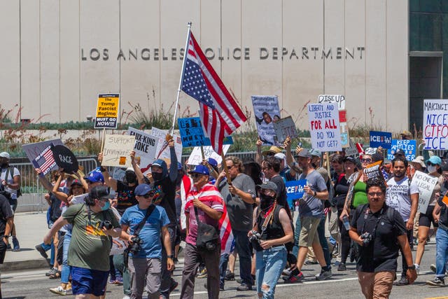 <p>Demonstrators protest against ICE outside the Los Angeles Police Department on Independence Day</p>