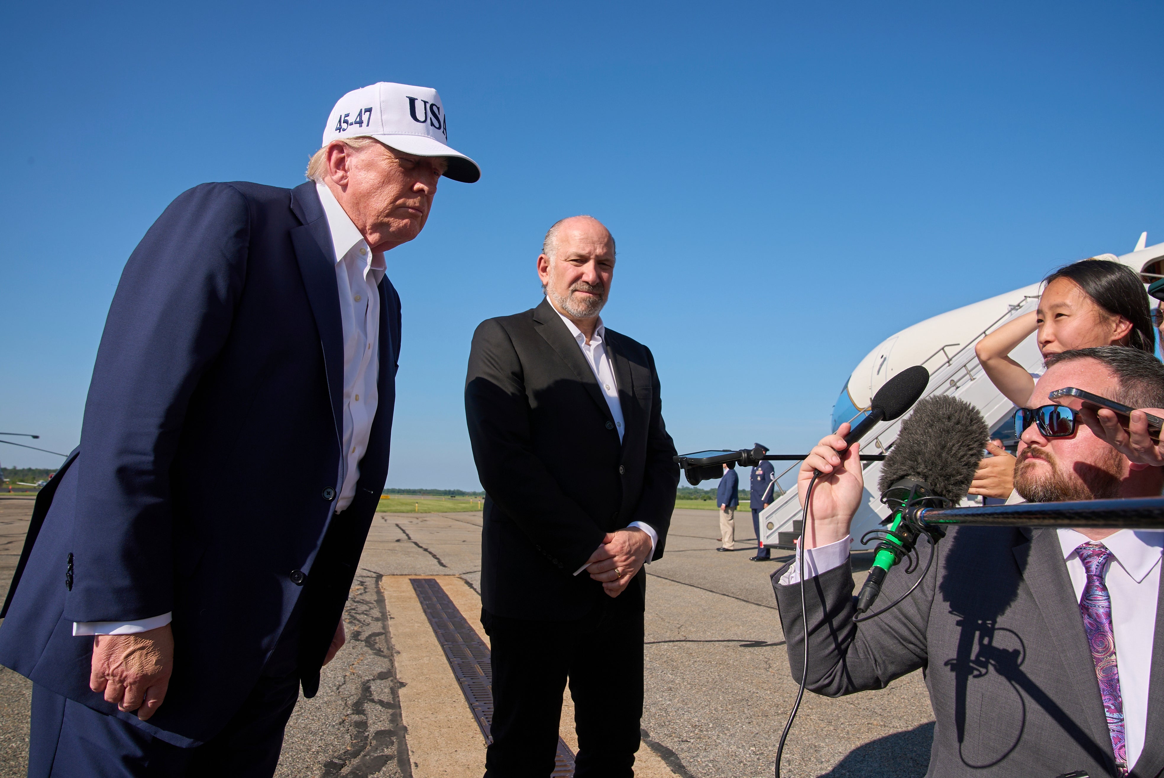 President Donald Trump leans in to hear a question from the media before boarding Air Force One, at Morristown Municipal Airport in Morristown, N.J., Sunday, July 6, 2025, en route to Washington after a weekend in New Jersey. (AP Photo/Jacquelyn Martin)