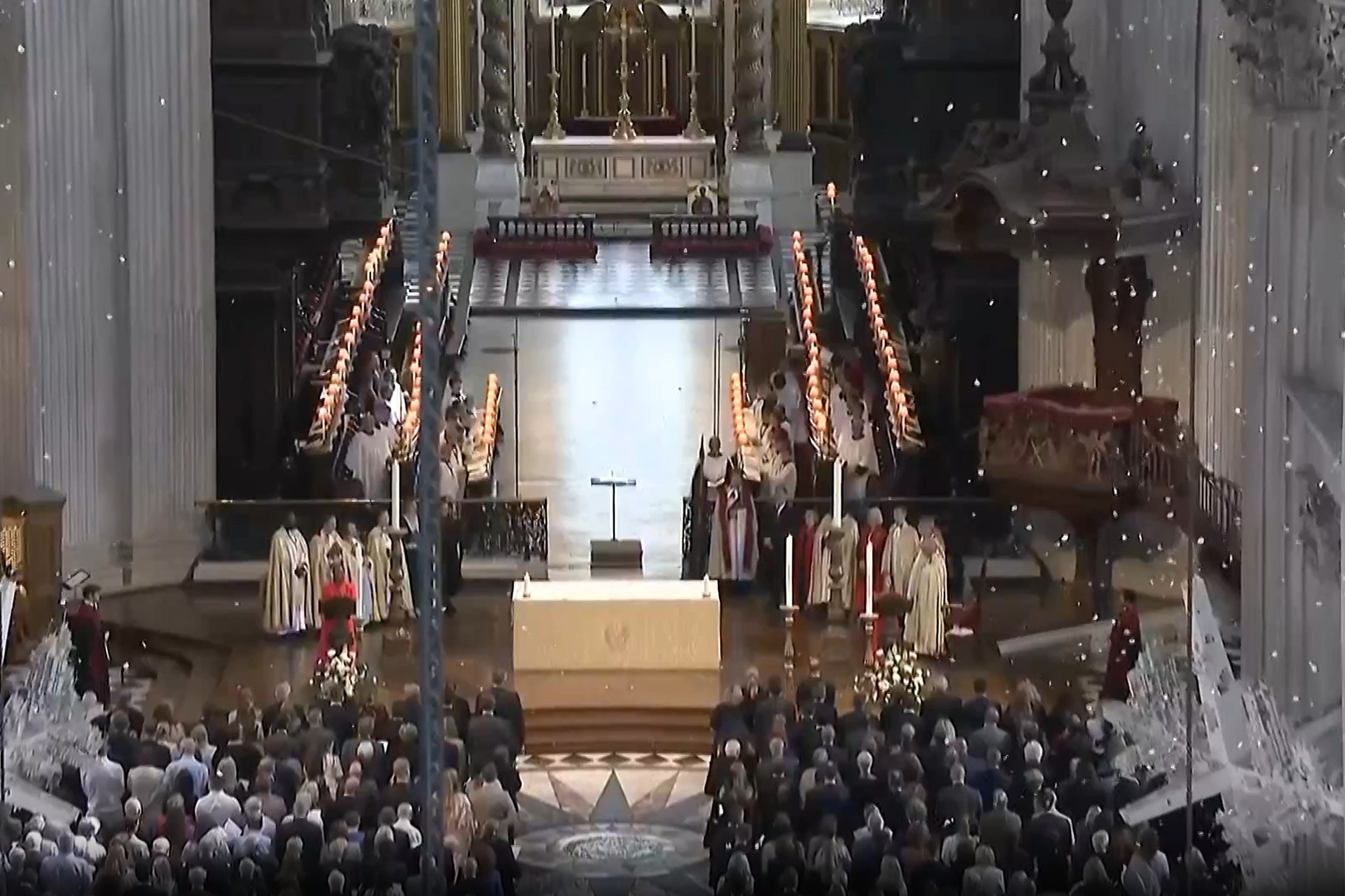As the names of the 52 people who died in the attacks were read out, 52,000 white petals fell from the ceiling of the dome (St Paul’s Cathedral/PA)