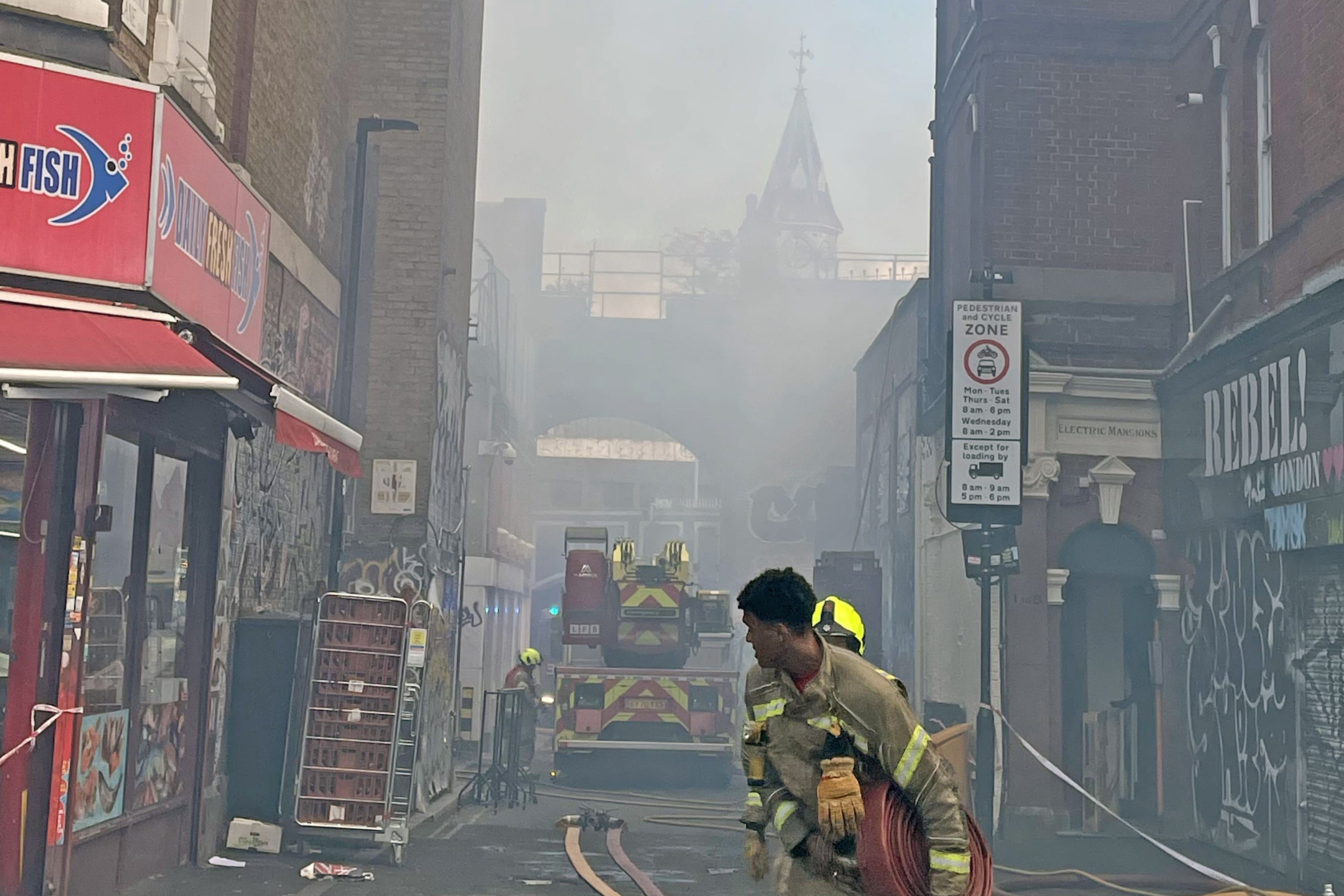 Firefighters at the scene on Electric Avenue in Brixton (PA)