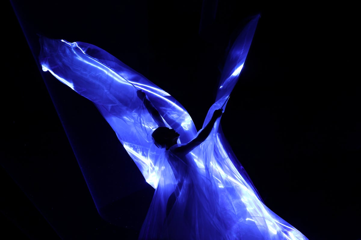 Iris Van Herpen unveils 'living' couture dress of bioluminescent algae in Paris