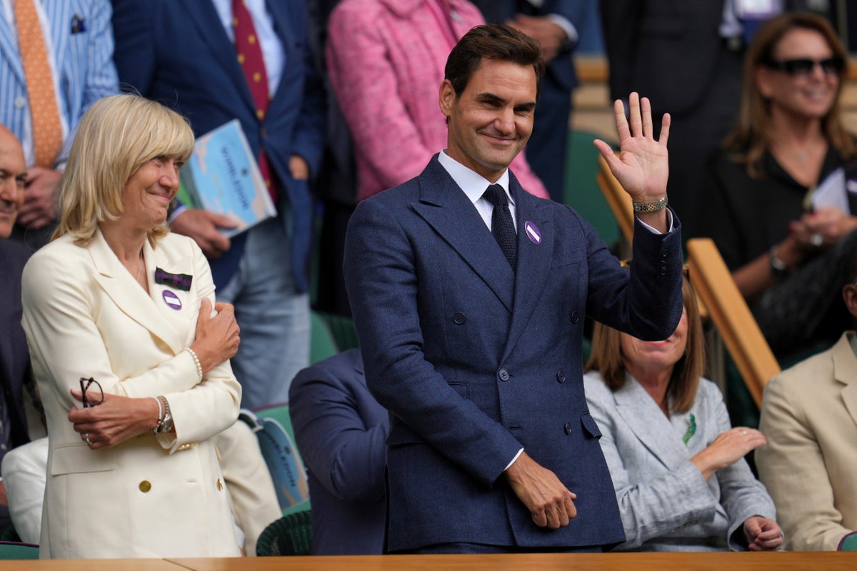 Roger Federer sits in Wimbledon's Royal Box to watch rival Novak Djokovic win