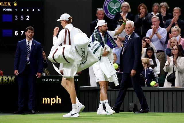 <p>Jannik Sinner (left) carrying Grigor Dimitrov's bags for him</p>