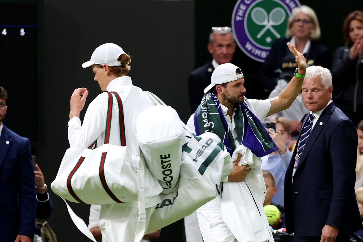 Jannik Sinner carries Grigor Dimitrov’s bags off court after heartbreaking retirement Jannik Sinner carries Grigor Dimitrov’s bags off court after heartbreaking retirement