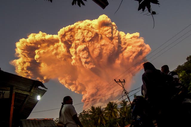 <p>Villagers watch the eruption of Mount Lewotobi Laki-Laki as seen from Talibura village in Sikka, East Nusa Tenggara, on 17 June 2025</p>