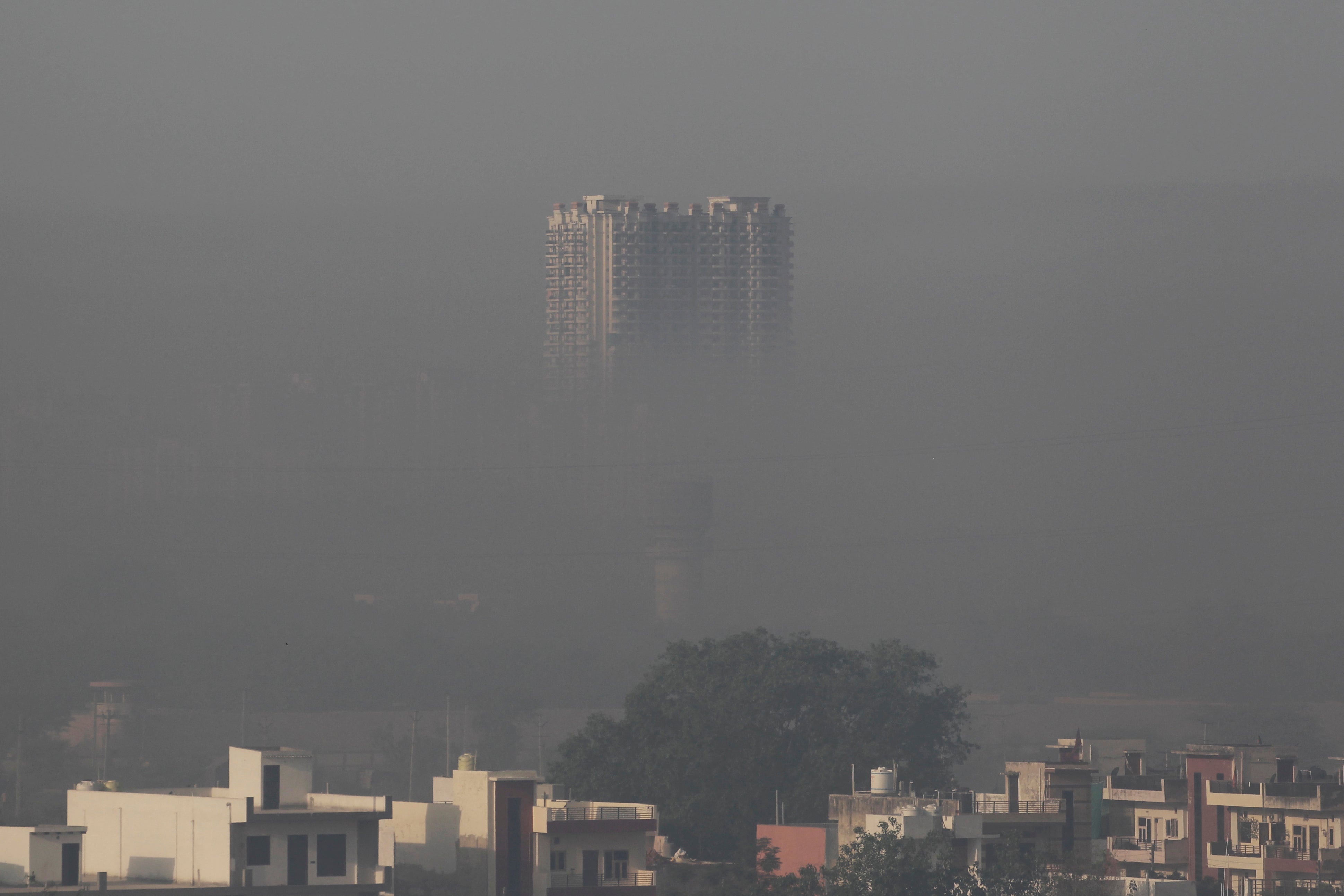 स्मोकी धुक्यात भरलेली एक निवासी इमारत हरियाणातील फरीदाबाद भागात सकाळी चित्रीत केली जाते