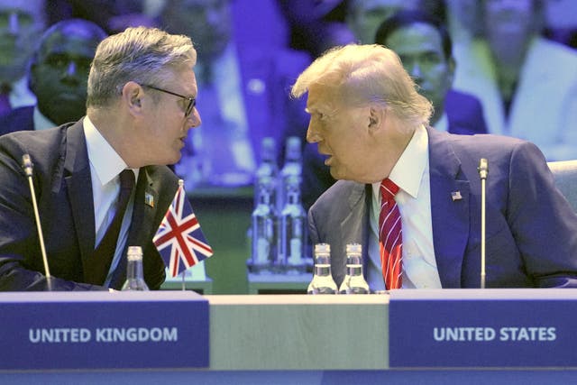 Prime Minister Sir Keir Starmer speaks with US President Donald Trump before the start of a North Atlantic Council plenary meeting during the Nato Summit at the Hague, Netherlands (Kin Cheung/PA)