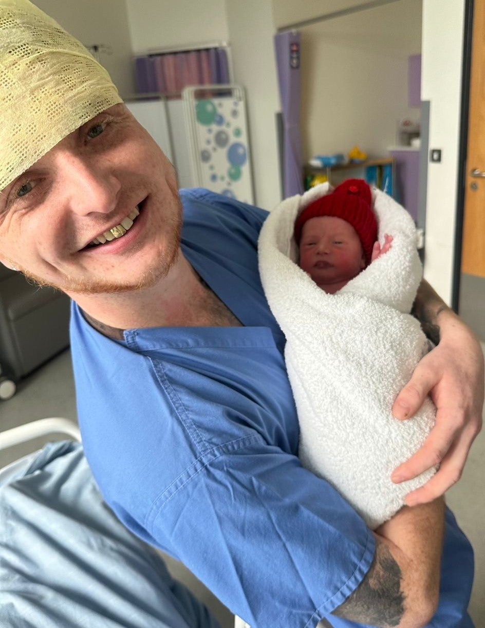 Scott with Lily it as a newborn baby