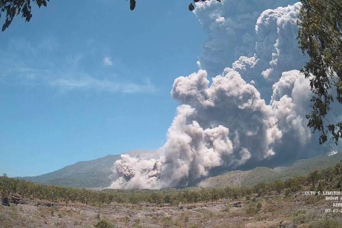 Residents wear masks as volcanic ash blankets villages near erupting Indonesian volcano