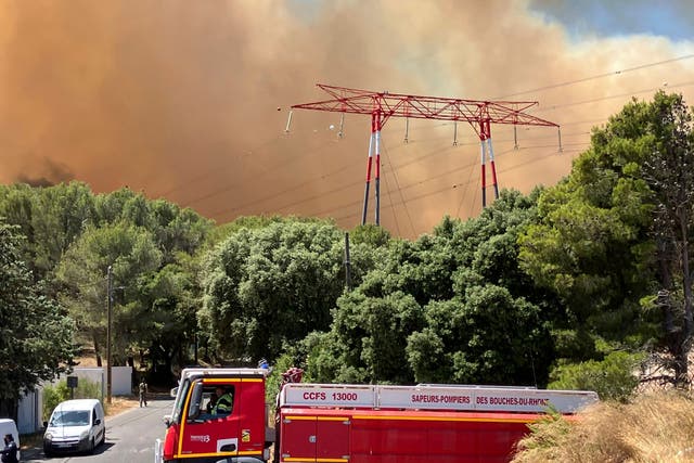 <p>Smoke rises during a wildfire near Marseille</p>