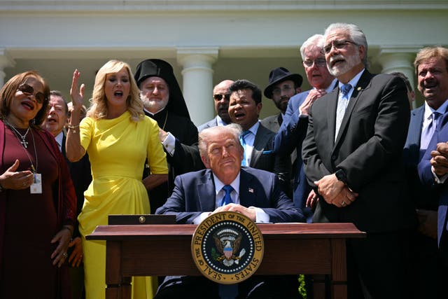 <p>Faith leaders join Donald Trump at a National Day of Prayer Event. After repeatedly pledging to repeal decades-old tax law that prevents churches from politicking, the IRS said on July 7 it would allow houses of worship to endorse candidates</p>