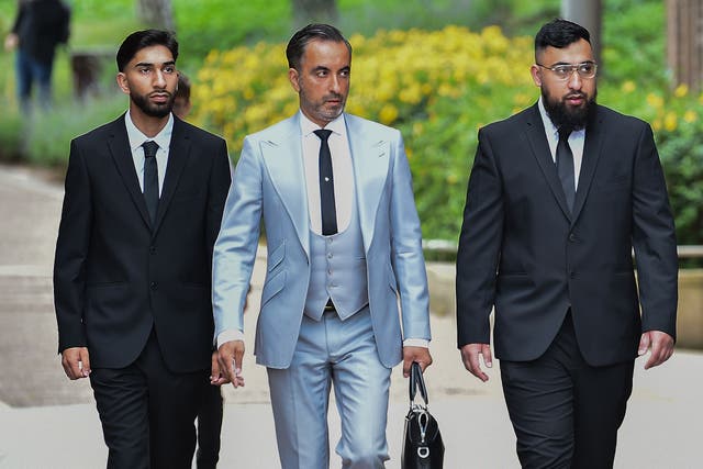 Human Rights lawyer Aamer Anwar (centre) arrives with Mohammed Fahir Amaaz (left) and Muhammed Amaad (right) at Liverpool Crown Court (Peter Powell/PA)