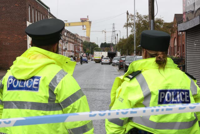 PSNI officers stand at a cordon (Liam McBurney/PA)