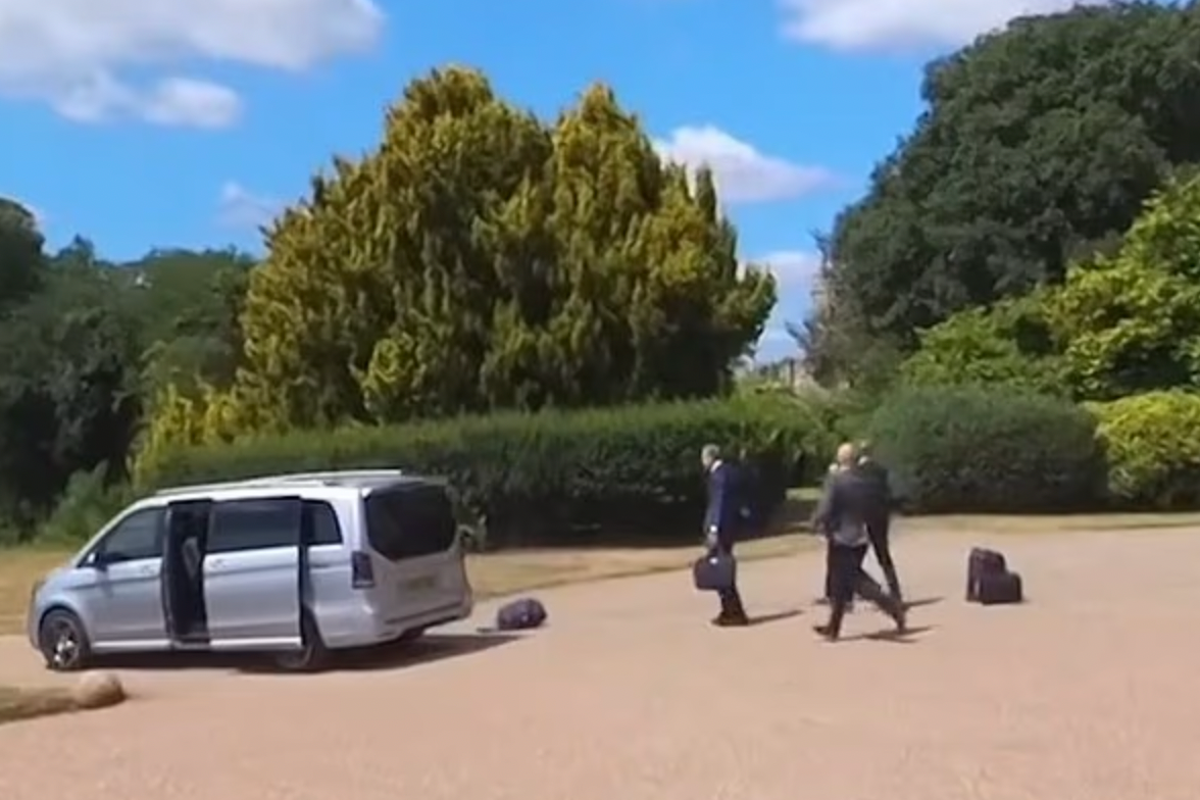 Moment Macron’s car speeds away from Windsor Castle as luggage goes flying from open boot