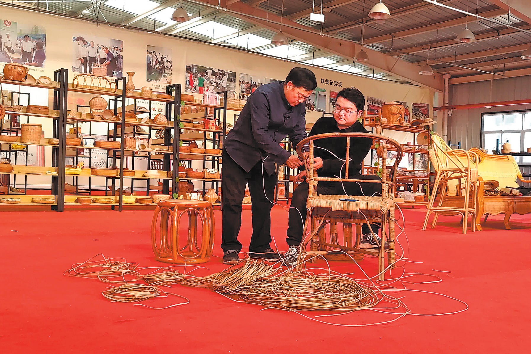 Chen Liangshun (left) instructs his son Chen Lingkai in rattan weaving