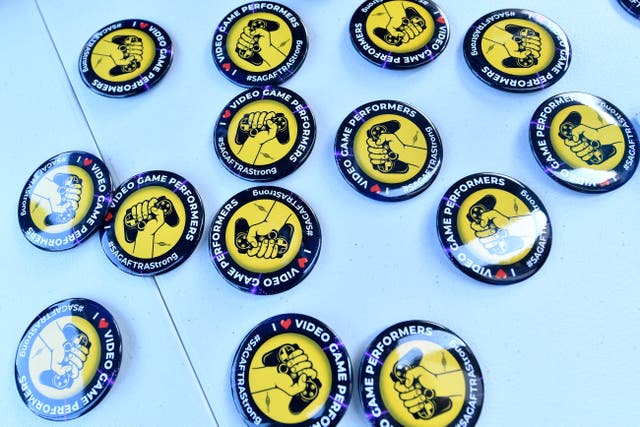 <p>Strike buttons are displayed as SAG-AFTRA union video game performers strike outside Warner Bros. Games</p>
