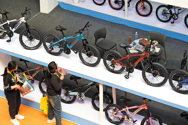 <p>Visitors look at the bicycle products on display at the 17th International Bicycles, Baby Strollers and Toys Fair in Pingxiang county, Hebei province, in April last year</p>