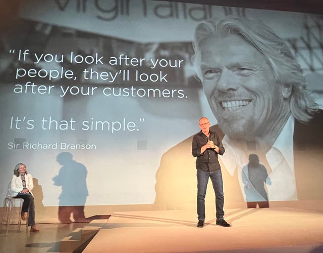 <p>Going places: Shai Weiss, CEO of Virgin Atlantic, on stage in front of an image of airline founder Sir Richard Branson; to the left, chief experience officer, Siobhan Fitzpatrick</p>