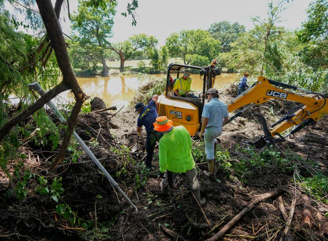 <p>First responders and volunteers conduct search and rescue work on the banks of the Guadalupe River in Ingram, Texas after floods ravaged the region</p>