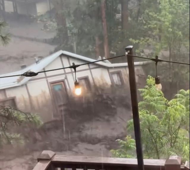 <p>A house is carried away by flash flooding behind a house in Ruidoso, New Mexico, on Tuesday July 8 2025</p>