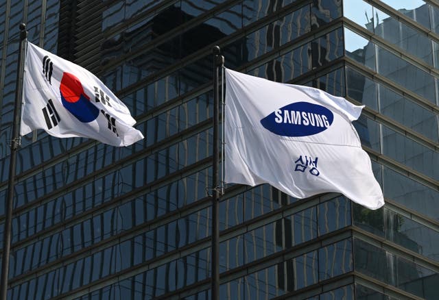 <p>The flags of South Korea (L) and Samsung (R) flutter outside the company's Seocho building in Seoul on 8 July 2025</p>