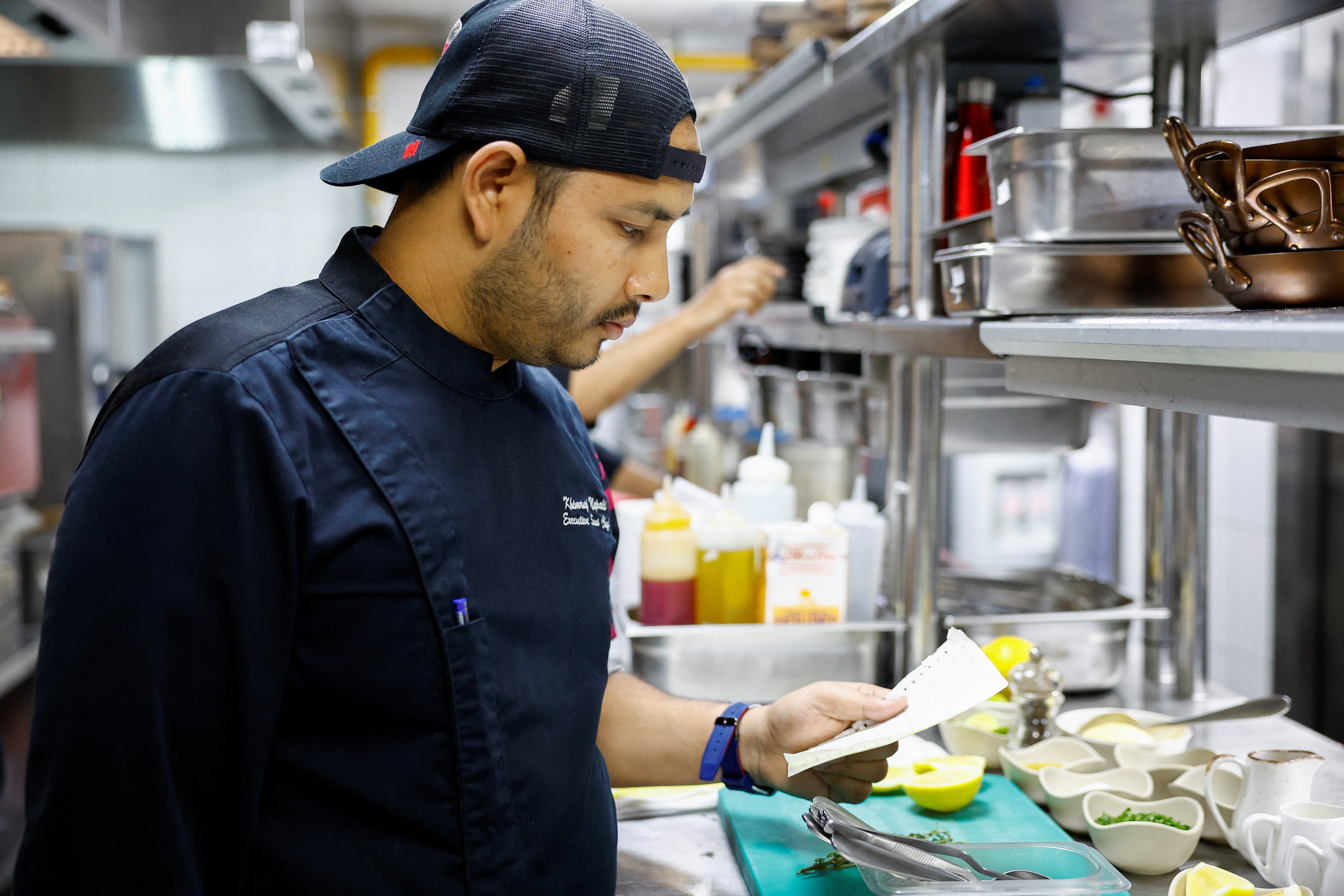 Nepali Chef's chef looks at the AI chef's recipe at the Trove Restaurant in Dubai