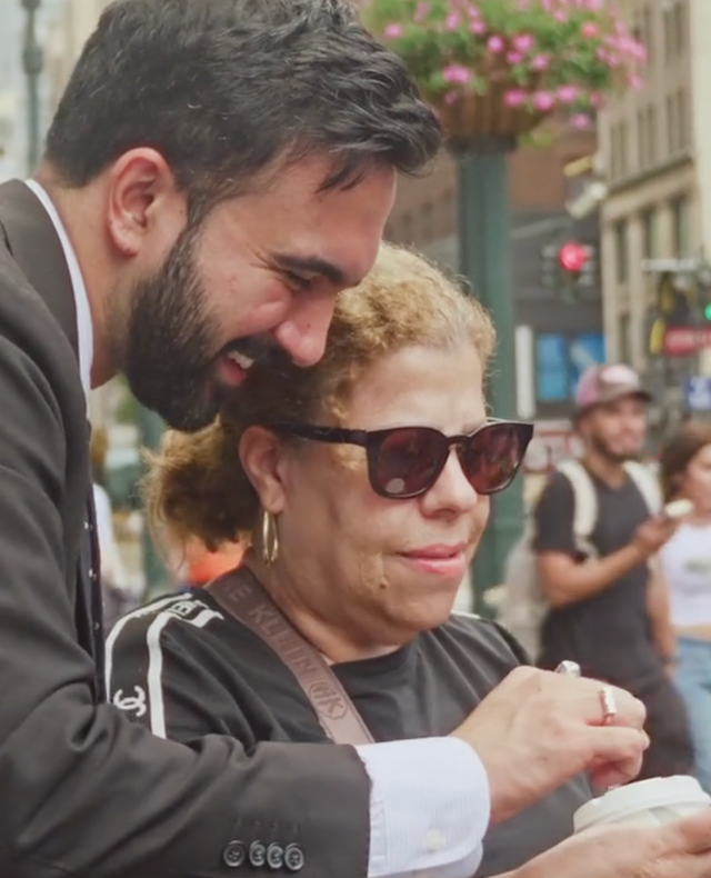 <p>New York City Democratic mayoral candidate Zohran Mamdani helps a fan take a selfie on the streets of Manhattan</p>
