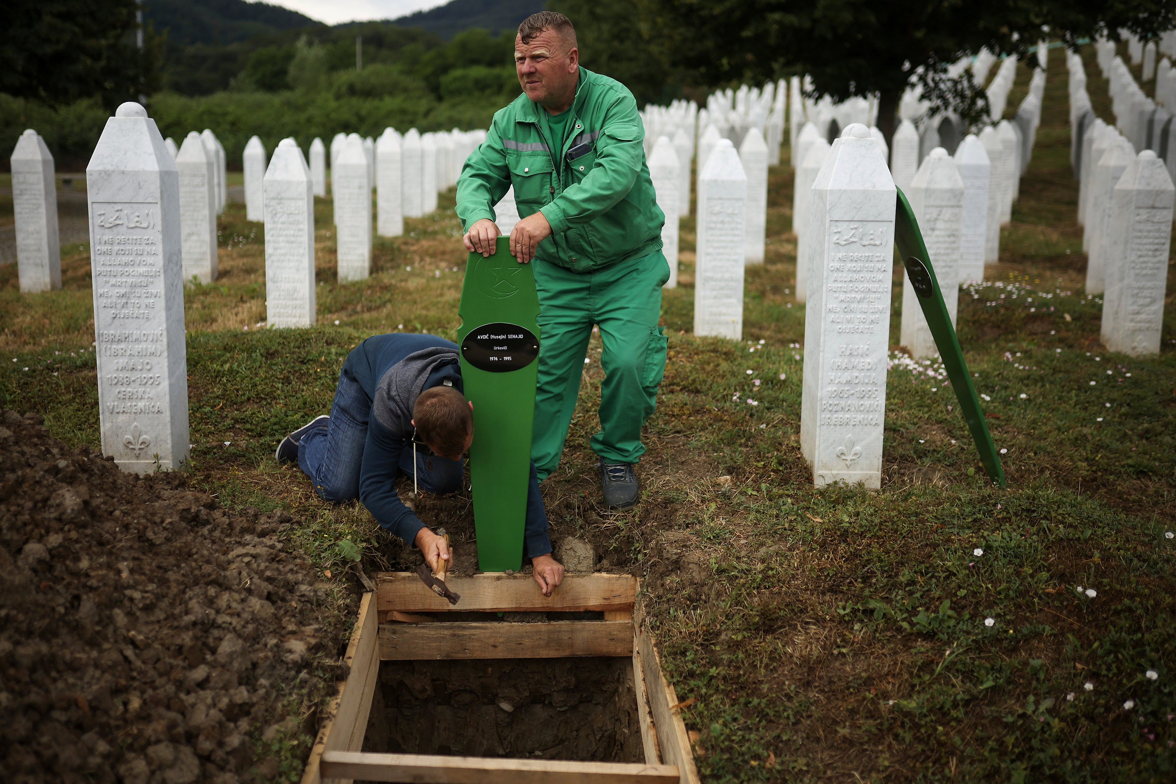 Cemetery workers are preparing graves for mass funnel seven newly initiative sacrifice in Srebrenica in 1995. in Potocari in Bosnia