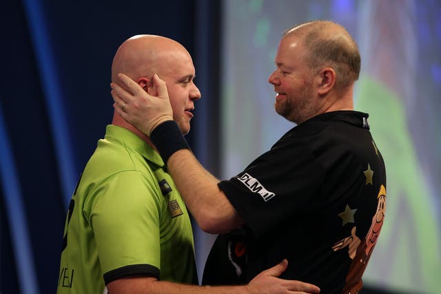 Michael van Gerwen, left, takes in Raymond van Barneveld in the first round at the World Matchplay (Steven Paston/PA)