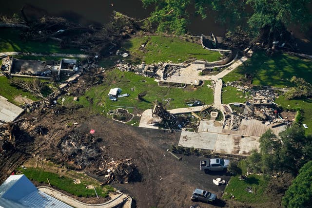 <p>The ruins of a building pictured in Hunt, Texas after Friday's devastating floods. Rescue crews say they're navigating 'mounds' of debris as they search for people</p>
