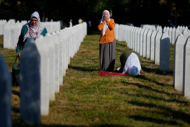 <p>Women pray at the Memorial Center for victims of the Srebrenica genocide in Potocari, Bosnia, Friday, July 11, 2025. (AP Photo/Darko Bandic)</p>