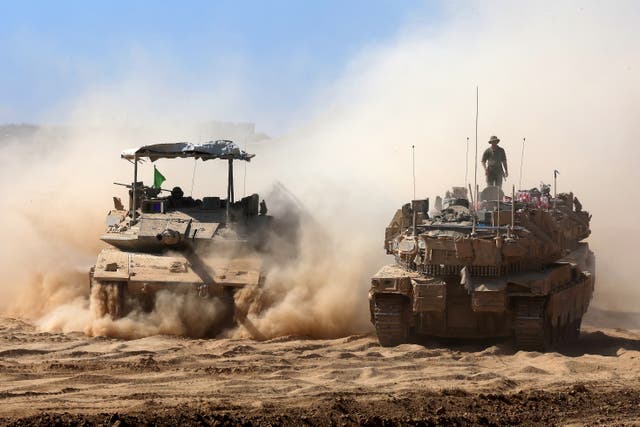 <p>Israeli troops deploy by the border fence with Gaza on 10 July 2025</p>